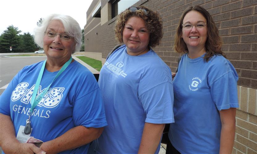 A group of teachers smile